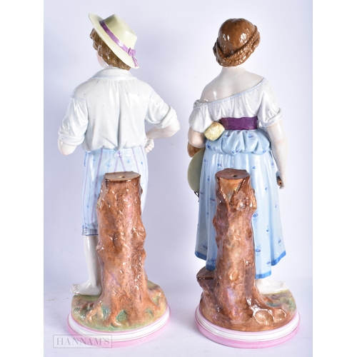 349 - A VERY LARGE PAIR OF 19TH CENTURY GERMAN PORCELAIN FIGURES modelled as a male and female beside a tr... 