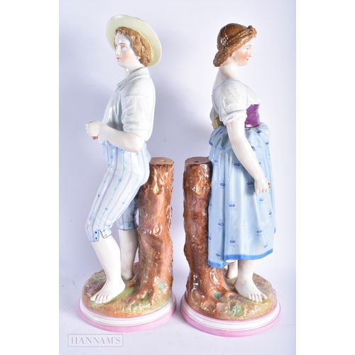 349 - A VERY LARGE PAIR OF 19TH CENTURY GERMAN PORCELAIN FIGURES modelled as a male and female beside a tr... 