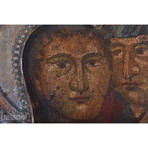 370 - AN 18TH CENTURY RUSSIAN PAINTED WOOD ICON contained with a scrolling gilt metal frame. 30 cm x 27cm.