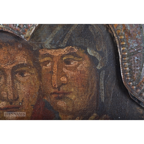 370 - AN 18TH CENTURY RUSSIAN PAINTED WOOD ICON contained with a scrolling gilt metal frame. 30 cm x 27cm.