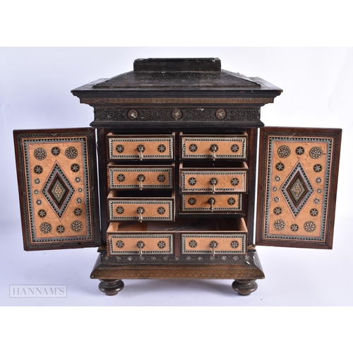 38 - A RARE 19TH CENTURY MIDDLE EASTERN WIRE INLAID CARVED WOOD TABLE CABINET decorated all over with mas... 