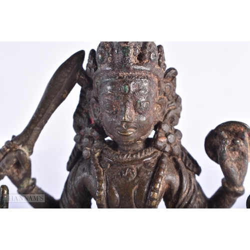 387 - AN 18TH CENTURY INDIAN BRONZE FIGURE OF KALI. 11.5 cm x 7 cm.