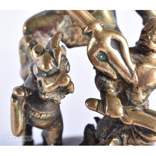 397 - AN 18TH CENTURY INDIAN BRONZE FIGURE OF DURGA modelled with attendants. 17 cm x 7 cm.