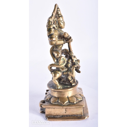 397 - AN 18TH CENTURY INDIAN BRONZE FIGURE OF DURGA modelled with attendants. 17 cm x 7 cm.