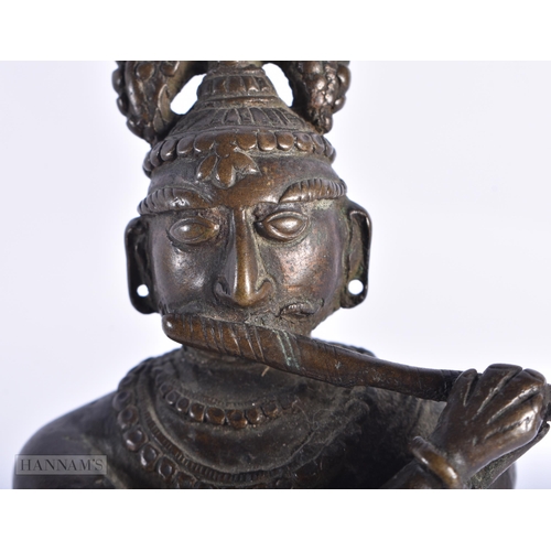 398 - A RARE 18TH CENTURY INDIAN BRONZE FIGURE OF KRISHNA unusually modelled with one leg reversed. 18cm h... 