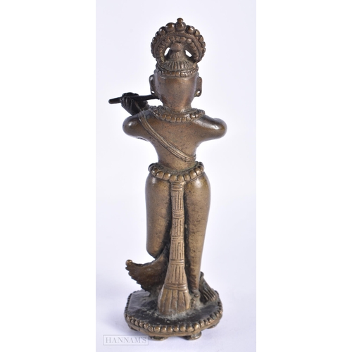 398 - A RARE 18TH CENTURY INDIAN BRONZE FIGURE OF KRISHNA unusually modelled with one leg reversed. 18cm h... 