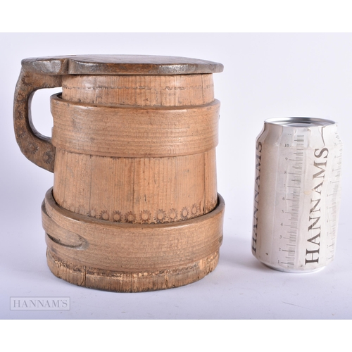 4 - AN ANTIQUE SCANDINAVIAN CARVED WOOD BANDED TANKARD. 16 cm x 14cm.