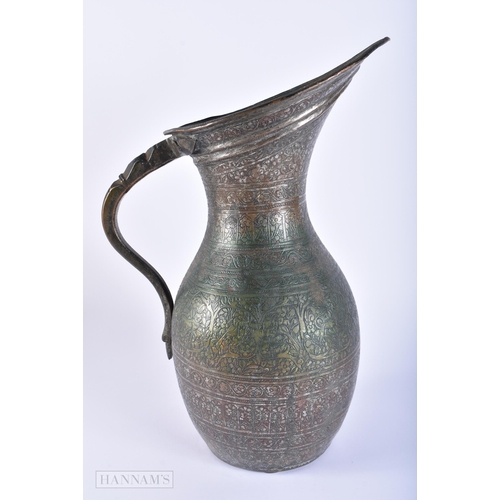 406 - A LARGE 18TH/19TH CENTURY PERSIAN ISLAMIC BRONZE ALLOY JUG decorated all over with birds, foliage an... 