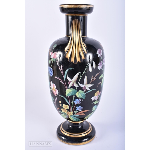 407 - A LOVELY VICTORIAN TWIN HANDLED ENAMELLED BLACK GLASS VASE painted with birds. 29 cm x 12 cm.