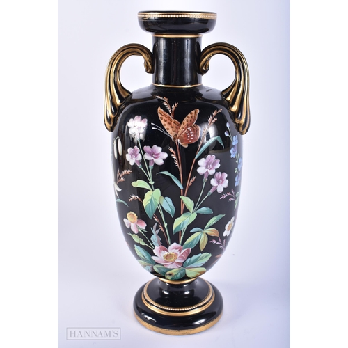 407 - A LOVELY VICTORIAN TWIN HANDLED ENAMELLED BLACK GLASS VASE painted with birds. 29 cm x 12 cm.