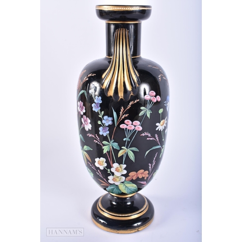 407 - A LOVELY VICTORIAN TWIN HANDLED ENAMELLED BLACK GLASS VASE painted with birds. 29 cm x 12 cm.