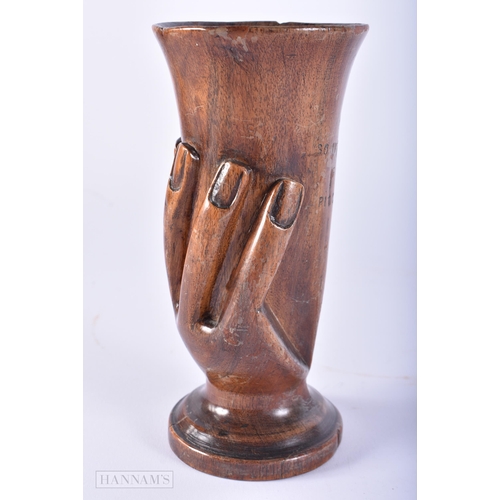 437 - AN UNUSUAL PITCAIRN ISLANDS CARVED WOOD VASE. 16 cm high.