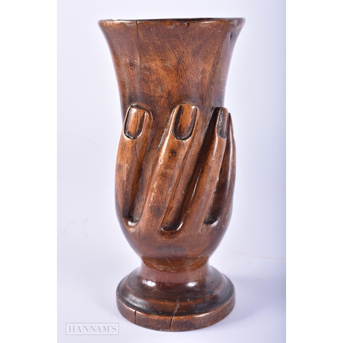 437 - AN UNUSUAL PITCAIRN ISLANDS CARVED WOOD VASE. 16 cm high.