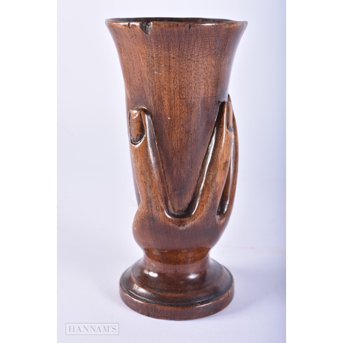 437 - AN UNUSUAL PITCAIRN ISLANDS CARVED WOOD VASE. 16 cm high.