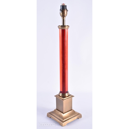 44 - AN UNUSUAL RUBY STEM BRASS LAMP. 46 cm high.