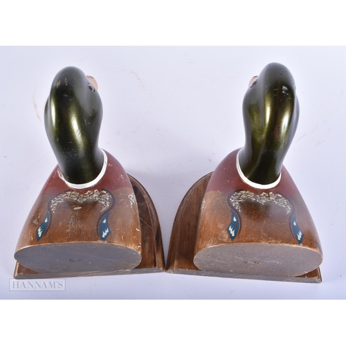 445 - AN UNUSUAL PAIR OF PAINTED WOOD FOLK ART DUCK BOOKENDS. Each end 18cm x 18cm.