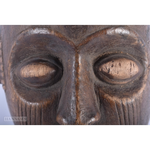 465 - AN AFRICAN CARVED WOOD TRIBAL MASK. 27cm x 14cm.