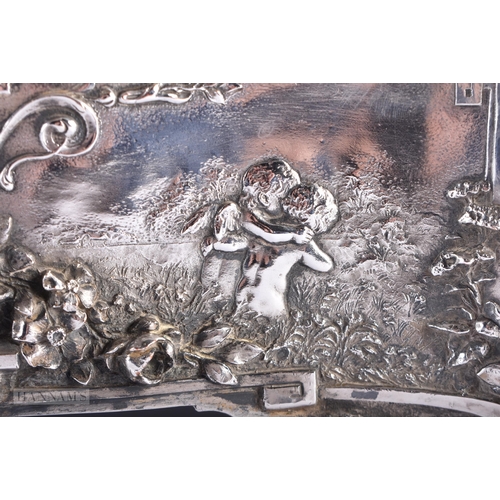 470 - A LARGE VICTORIAN WALKER & HALL SILVER PLATED REPOUSSE CASKET decorated with figures within landscap... 