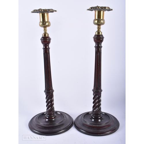 484 - A PAIR OF ANTIQUE MAHOGANY CANDLESTICKS together with a pair of Islamic bronze vases. Largest 35 cm ... 