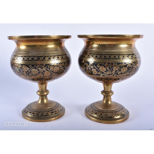 484 - A PAIR OF ANTIQUE MAHOGANY CANDLESTICKS together with a pair of Islamic bronze vases. Largest 35 cm ... 