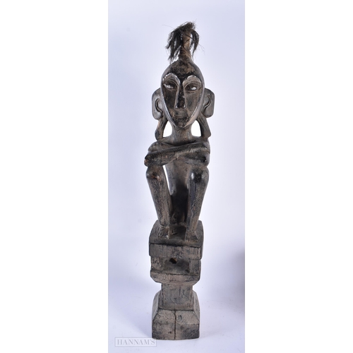 496 - AN AFRICAN TRIBAL CARVED WOOD FIGURE together with a pair of Oriental carved wood tigers and an over... 