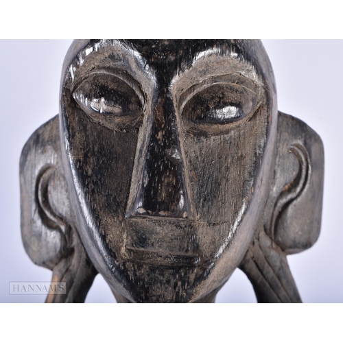 496 - AN AFRICAN TRIBAL CARVED WOOD FIGURE together with a pair of Oriental carved wood tigers and an over... 