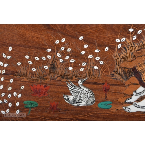 501 - A LARGE EARLY 20TH CENTURY INDIAN CARVED WOOD TRAY inlaid with a female feeding ducks. 60cm x 30 cm.