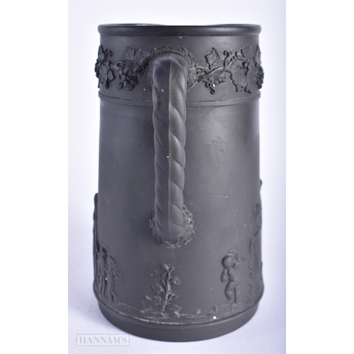 520 - A WEDGWOOD BLACK BASALT JUG. 15cm high.