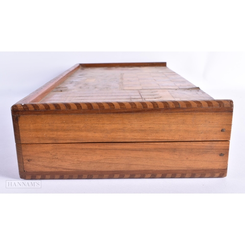 56 - A LARGE EARLY 20TH CENTURY MIXED WOOD FOLDING GAMING BOARD with counters. 54 cm x 46cm open.