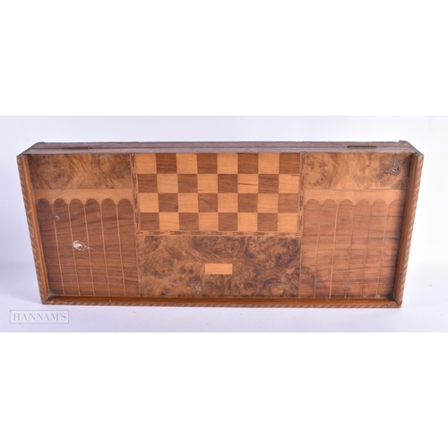 56 - A LARGE EARLY 20TH CENTURY MIXED WOOD FOLDING GAMING BOARD with counters. 54 cm x 46cm open.