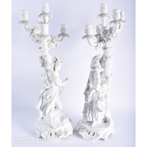 582 - A LARGE PAIR OF LATE 19TH CENTURY GERMAN BLANC DE CHINE CANDLESTICKS. 58 cm x 16 cm.