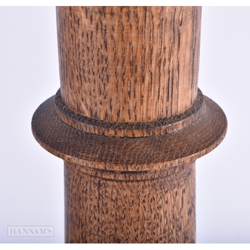 5 - A PAIR OF ENGLISH MULBERRY OAK TURRET FORM CANDLESTICKS. 42cm high.