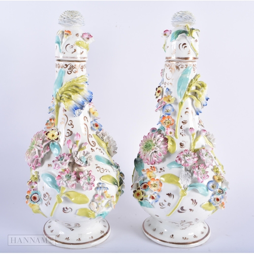 594 - A PAIR OF MID 19TH CENTURY ENGLISH PORCELAIN VASES AND COVER encrusted with flowers. 28cm high.