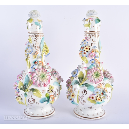 594 - A PAIR OF MID 19TH CENTURY ENGLISH PORCELAIN VASES AND COVER encrusted with flowers. 28cm high.