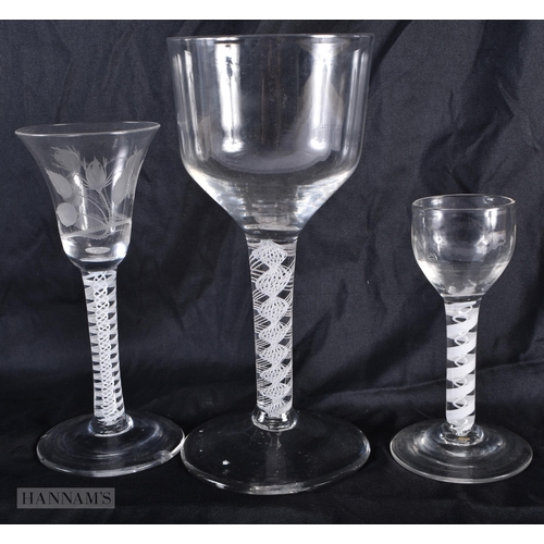 599 - THREE ANTIQUE ENGLISH WHITE TWIST STEM GLASSES. Largest 20 cm high. (3)