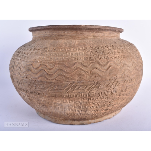 602 - A LARGE EARLY SOUTH AMERICAN OR AFRICAN STONEWARE JAR decorated with assorted incised and raised mot... 