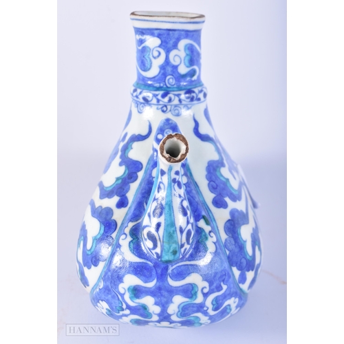 651 - A TURKISH IZNIK POTTERY WINE EWER. 18cm x 17 cm.