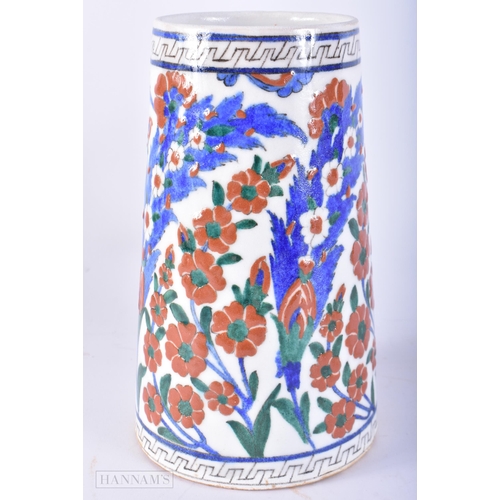 669 - A TURKISH ISLAMIC IZNIK FAIENCE POTTERY MUG. 20 cm high.