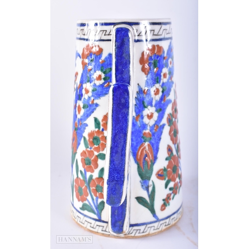 669 - A TURKISH ISLAMIC IZNIK FAIENCE POTTERY MUG. 20 cm high.