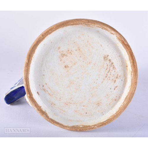 669 - A TURKISH ISLAMIC IZNIK FAIENCE POTTERY MUG. 20 cm high.