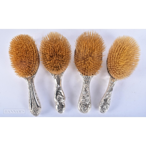 701 - FOUR ANTIQUE SILVER BACKED BRUSHES. Largest 28cm long. (4)