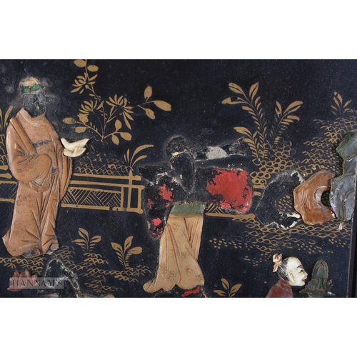 703 - A 19TH CENTURY CHINESE BLACK LACQUER SOAPSTONE SCREEN decorated with figures in various pursuits. 90... 