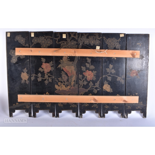 703 - A 19TH CENTURY CHINESE BLACK LACQUER SOAPSTONE SCREEN decorated with figures in various pursuits. 90... 