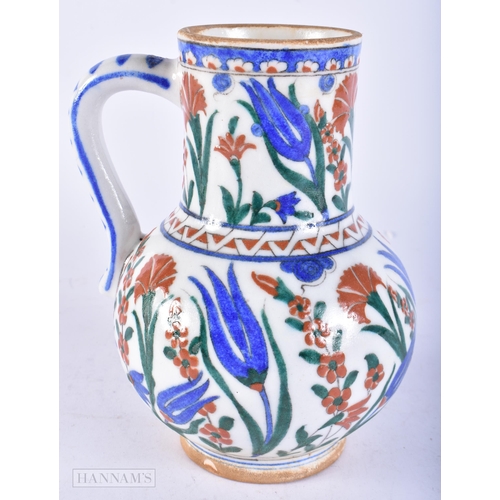 719 - A TURKISH IZNIK POTTERY FAIENCE JUG. 19 cm high.