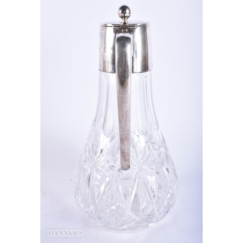 766 - AN ANTIQUE CONTINENTAL SILVER CUT GLASS CLARET JUG. 28cm high.