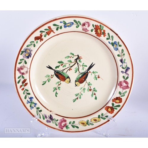 83 - A PAIR OF 18TH CENTURY ENGLISH CREAMWARE POTTERY PLATES painted with birds. 21 cm diameter.