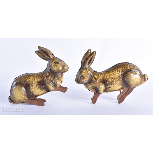 89 - A PAIR OF VINTAGE TIN PLATE TOY RABBITS. 14cm wide.