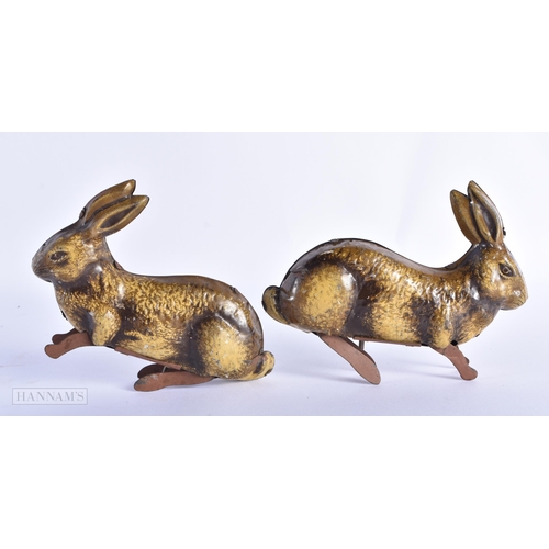 89 - A PAIR OF VINTAGE TIN PLATE TOY RABBITS. 14cm wide.