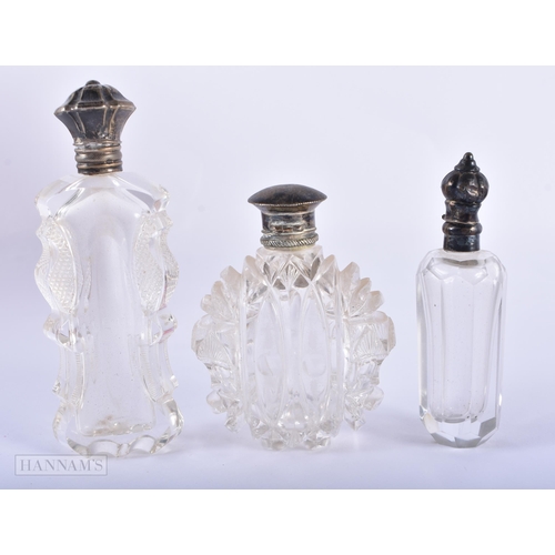 1277 - THREE ANTIQUE SILVER MOUNTED GLASS SCENT BOTTLES. 338 grams overall. Largest 10.75 cm x 4.5 cm. (3)