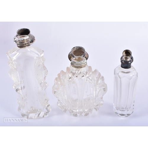 1277 - THREE ANTIQUE SILVER MOUNTED GLASS SCENT BOTTLES. 338 grams overall. Largest 10.75 cm x 4.5 cm. (3)